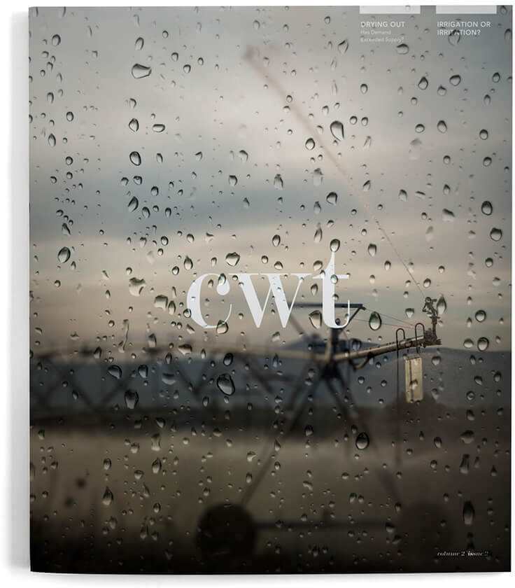 CWT Magazine Issues, image looking out a window of water drops onto a field where the irrigation system is running