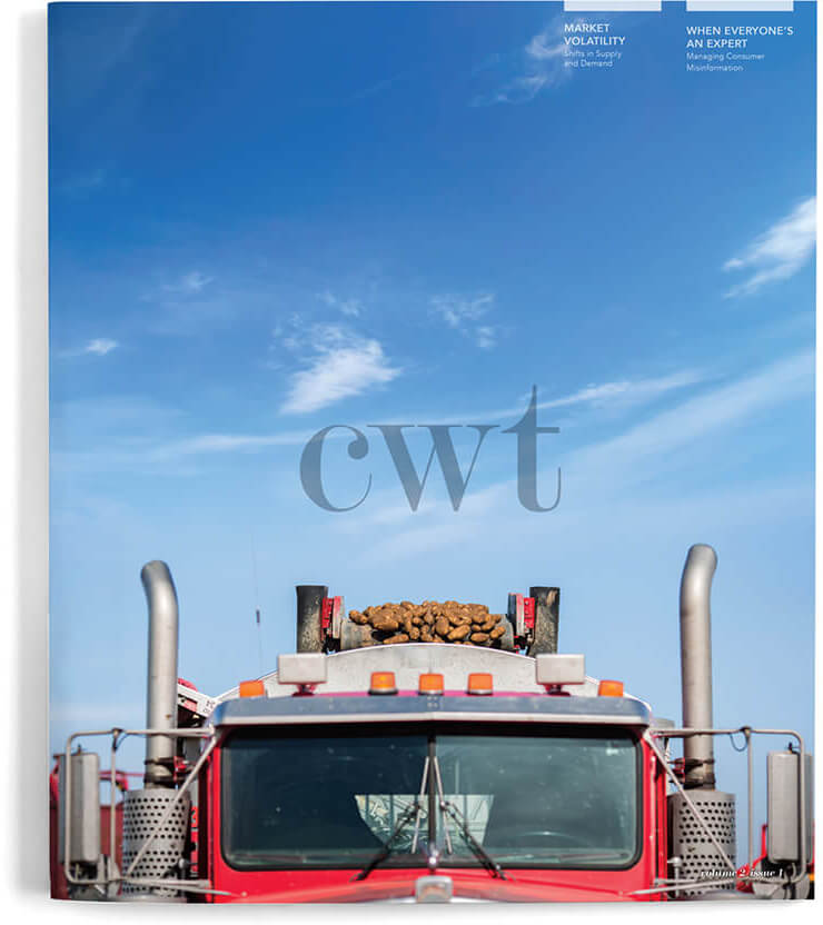 CWT Magazine Issues, image of collecting potatoes on a conveyor belt into the back of the dump truck from a farmers field